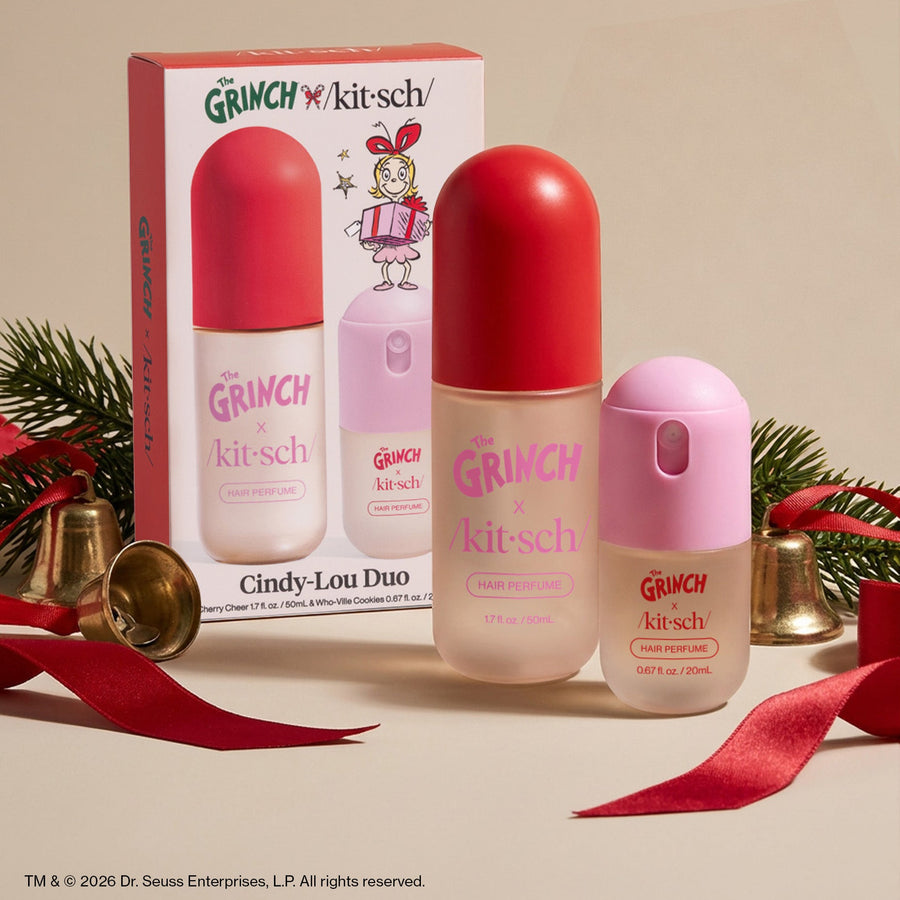 The Grinch x Kitsch Cindy-Lou Duo Set box and bottles styled with holiday bells and red ribbon