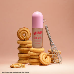 Model misting The Grinch x Kitsch Whoville Cookies Hair Perfume onto hair