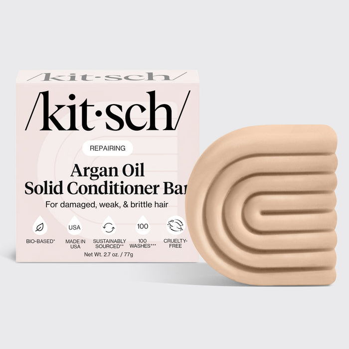 KITSCH Repairing Argan Oil Conditioner Bar — hero product shot on light gray background — REPAIRING Argan Oil Solid Conditioner Bar retail box with bar — For damaged, weak, & brittle hair — Bio-based | Made in USA | Sustainably Sourced | 100 Washes | Cruelty-Free — Net Wt. 2.7 oz / 77g — Packed with antioxidant-rich argan oil to help boost moisture without weighing it down