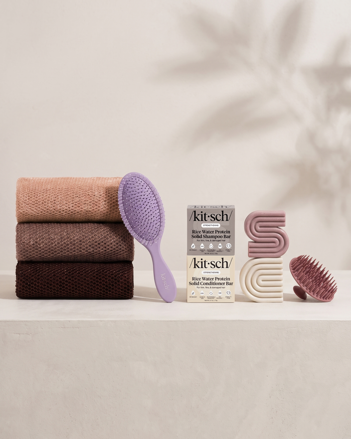 Kitsch Spring Welcome Kit Rice Water shown as a full bundle with the Strengthening Rice Water Shampoo and Conditioner Bars, Soft Violet Wet/Dry Brush, Terracotta Scalp Exfoliator and Rosewood African Net Sponge on a soft neutral background